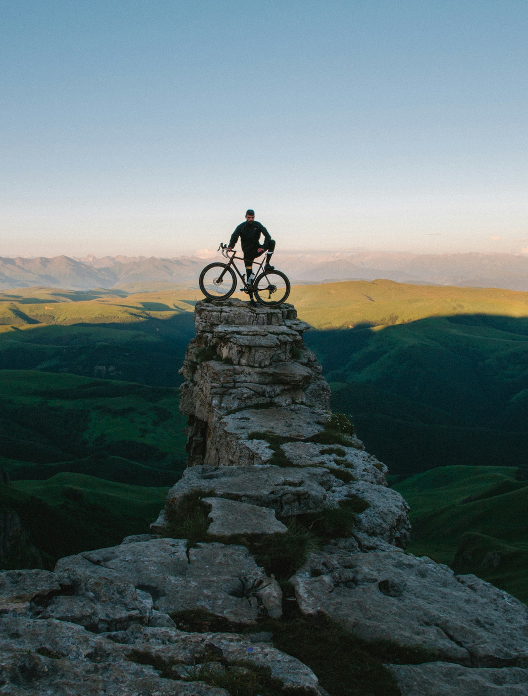 A man on a rock with his bike